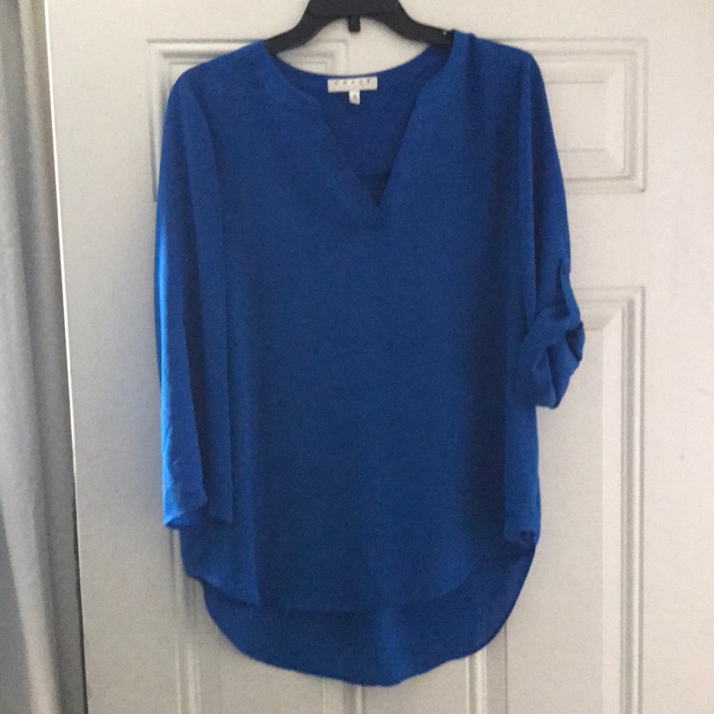 Blouse with sleeves that button shorter